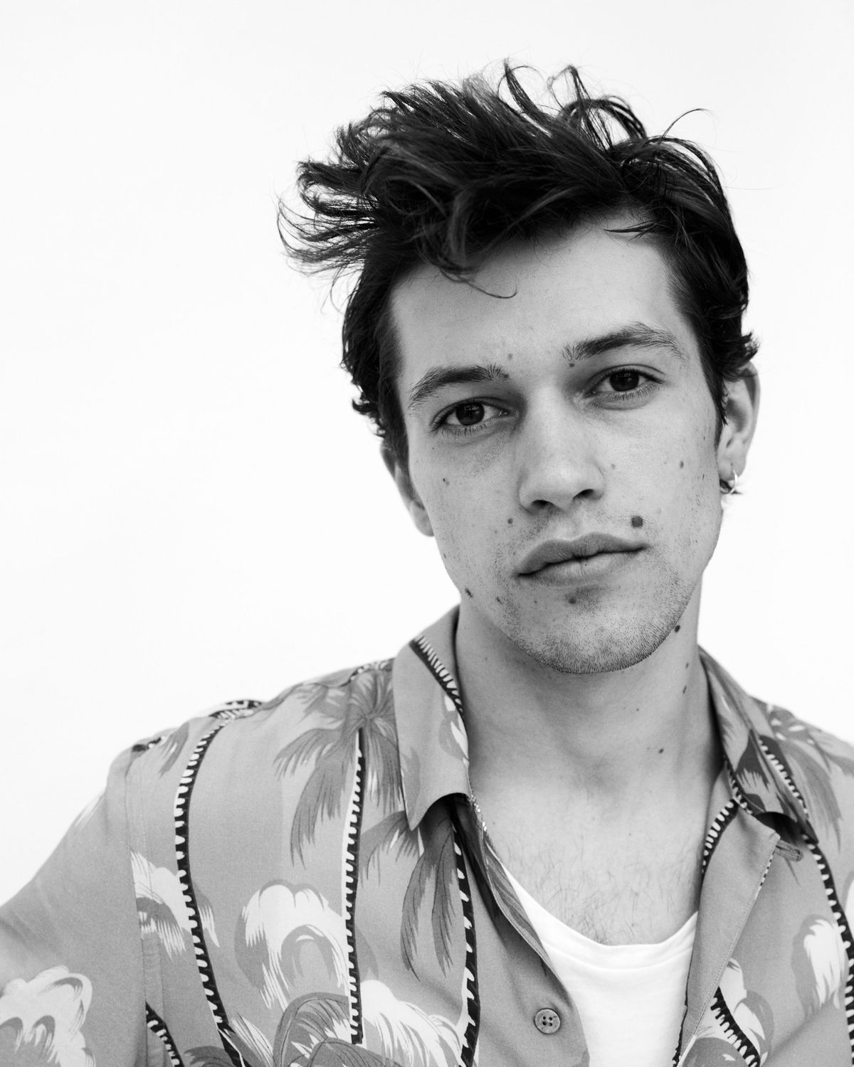 Close-up monochrome portrait of a young man from our new Biker Portraits series, wearing a hawaiian printed shirt from our latest collection.