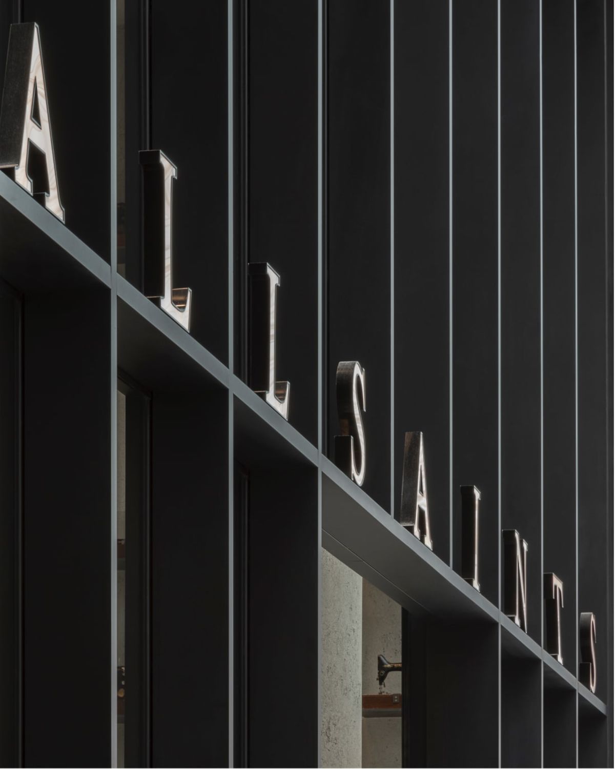 AllSaints sign above a store entrance.