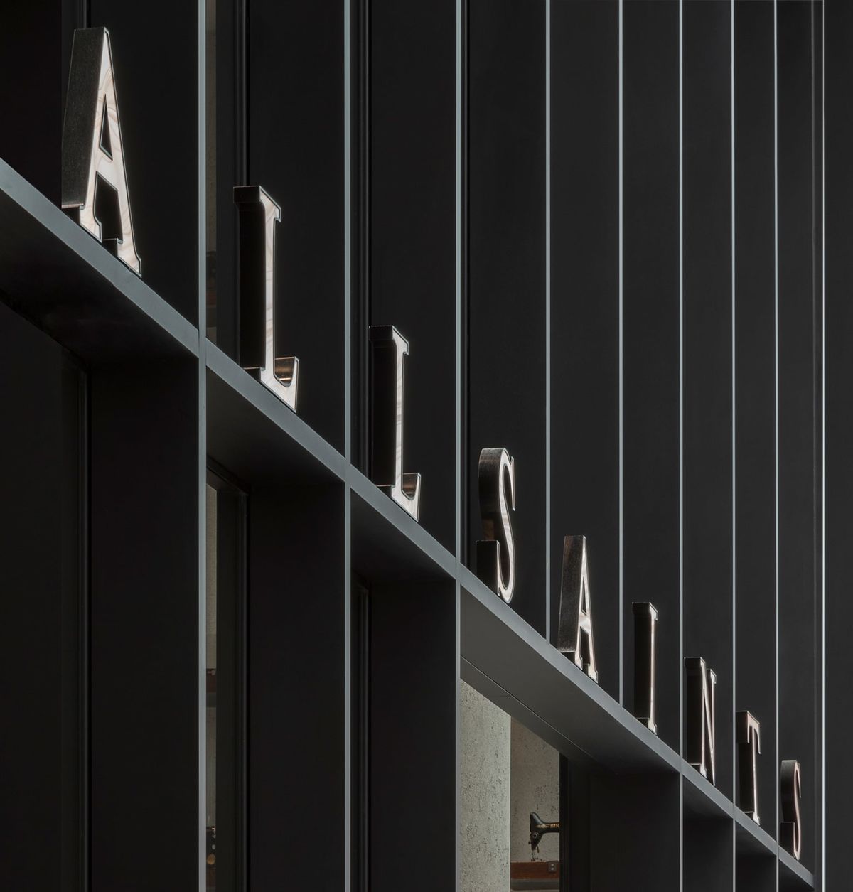 AllSaints sign above a store entrance.