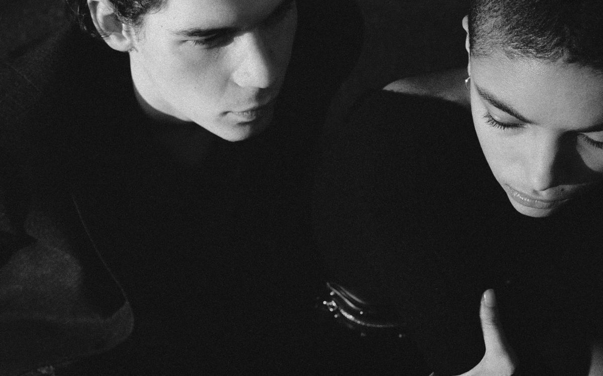 Black and white close up image of a woman and a man wearing dark winter clothes.