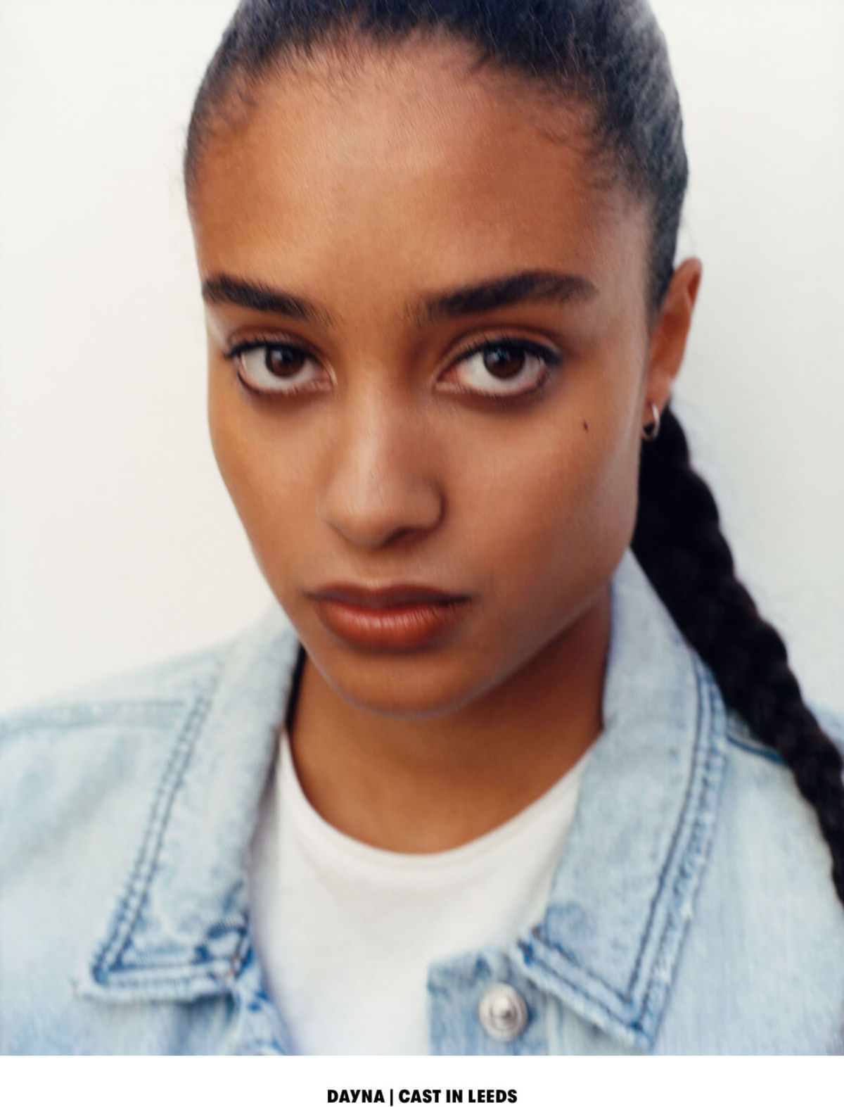 DAYNA | CAST IN LEEDS. Close up portrait of a woman wearing a light denim jacket over a white t-shirt.