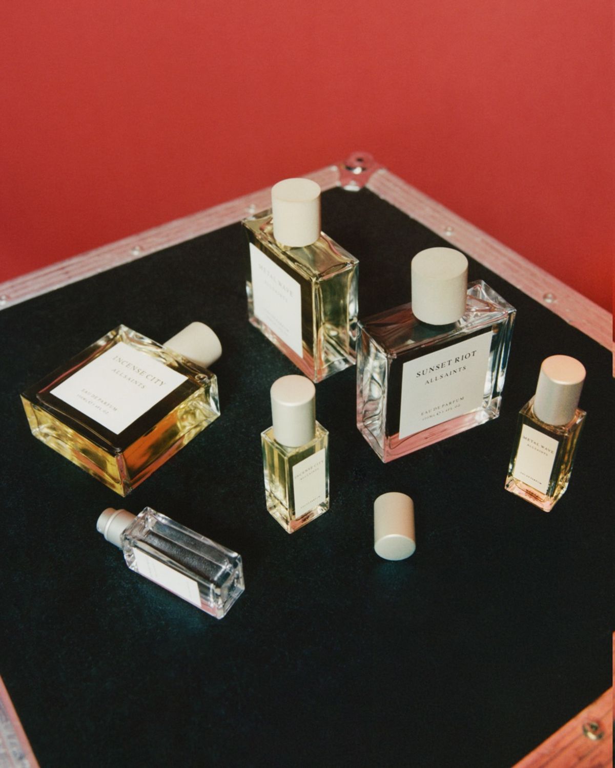 Image of our fragrance sets in front of a red background.