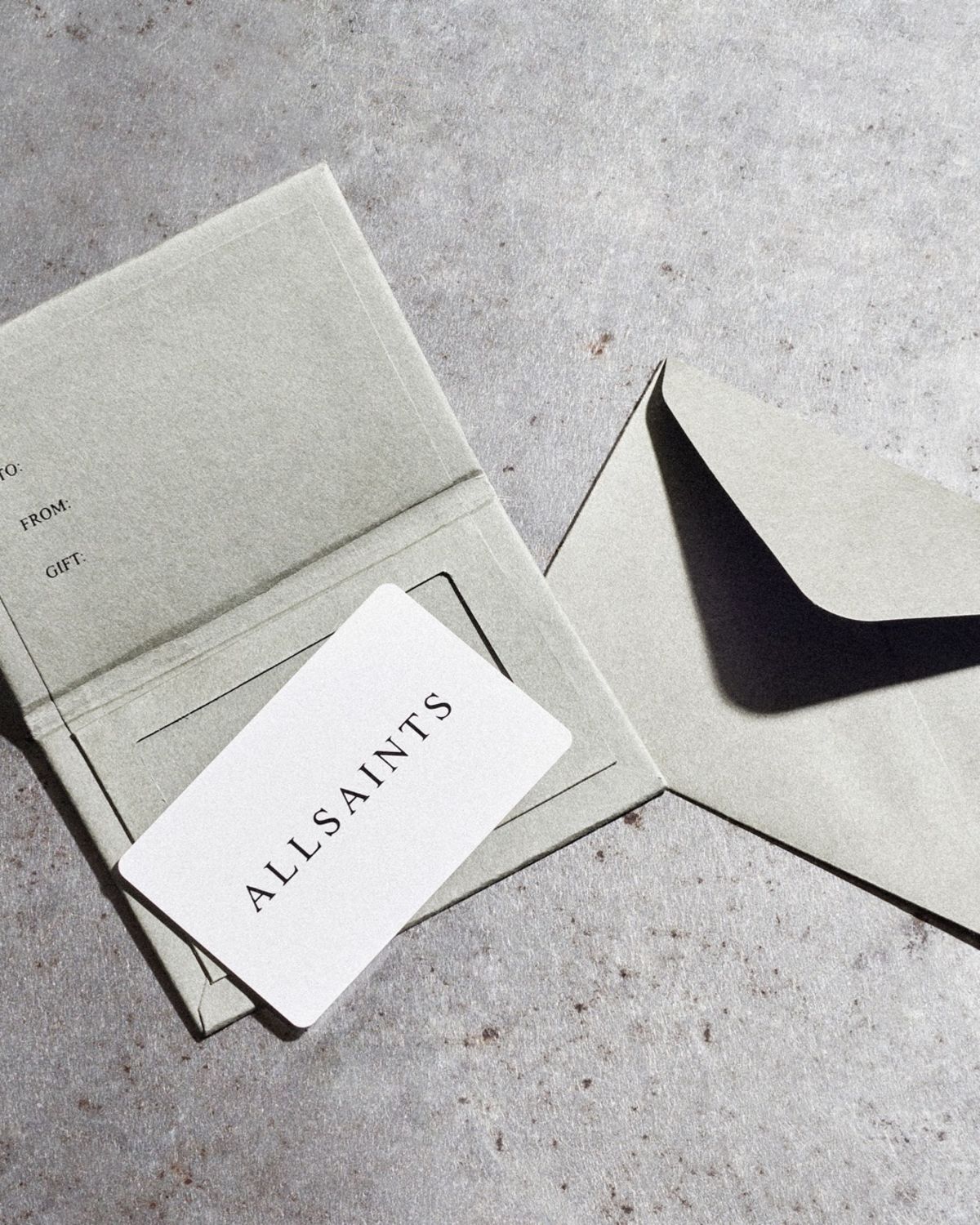 Image of an AllSaints gift card on a grey background.