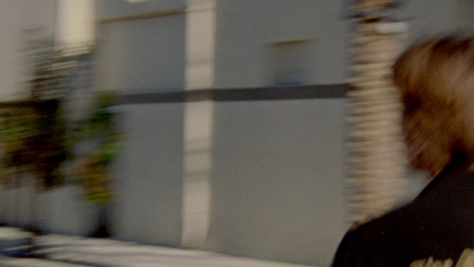 Mini-clip screenshot of a man running in the street wearing our latest collection.