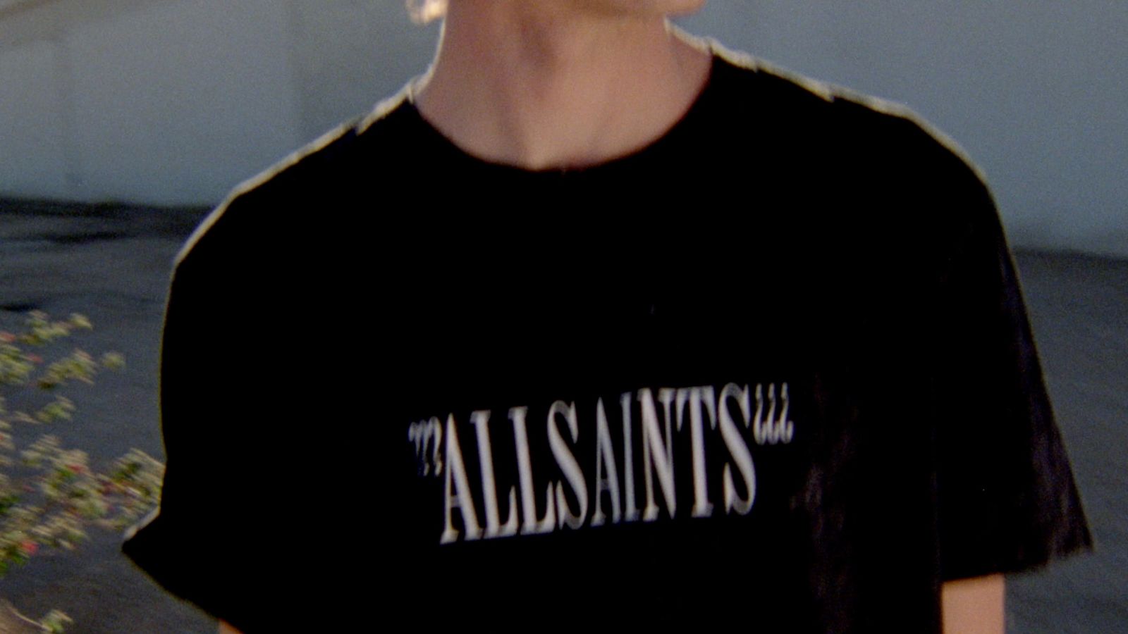 Mini-clip screenshot of a man wearing a black t-shirt with a white logo accross the chest from out latest collection.