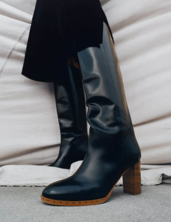 Close up shot of women's knee-hight leather boots.