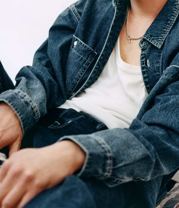 Front shot of a man wearing blue jeans and a denim shirt.