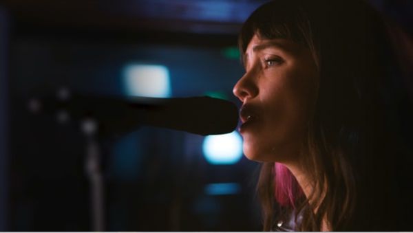 Close up portrait of Tishmal singing.