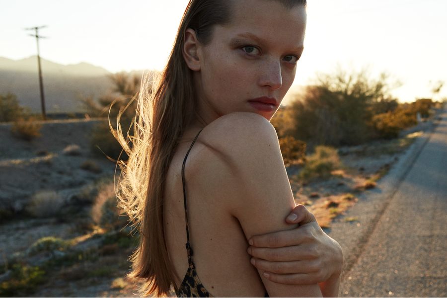 Ritratto di una donna che indossa un abito leopardato con spalline sottili al tramonto..