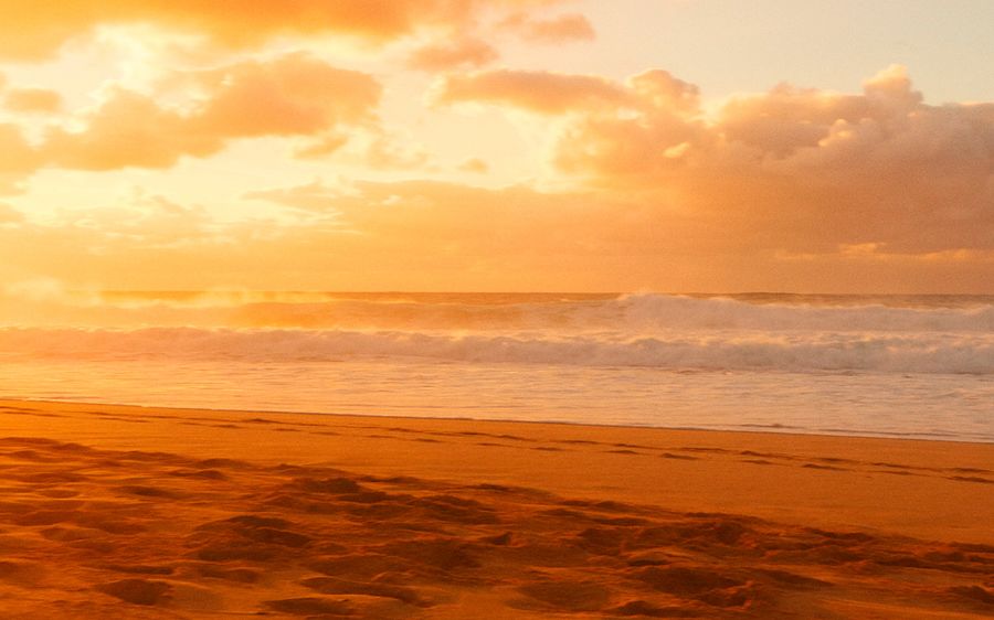Landscape picture of a beach at sunset.