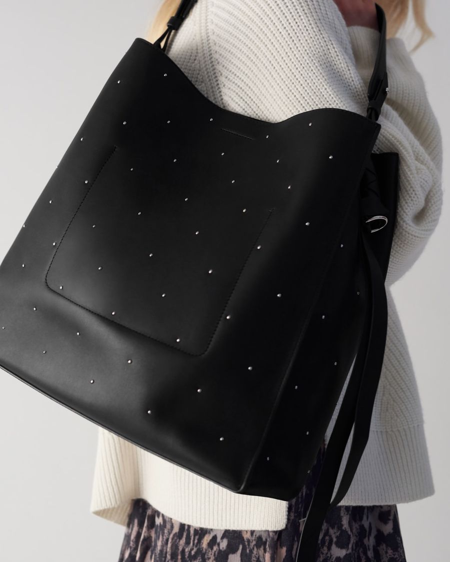 Close up off a black leather studded bag.