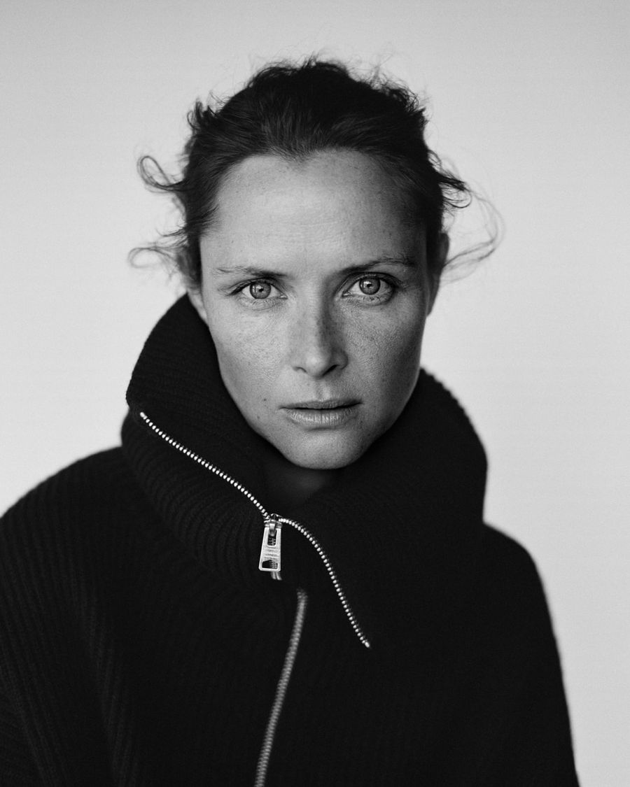 Black and white portrait of a woman wearing a zipped roll neck jumper.