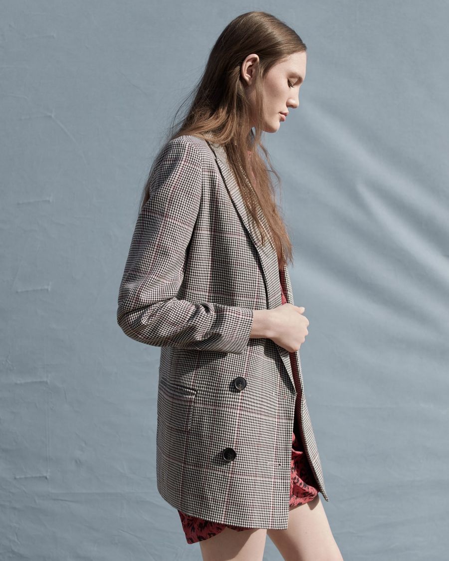 Image of a woman wearing a checked tailored jacket.