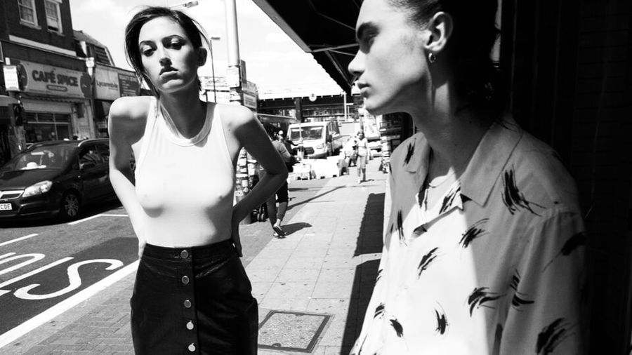 Black and white image of a couple in a stree wearing items from our latest collection.