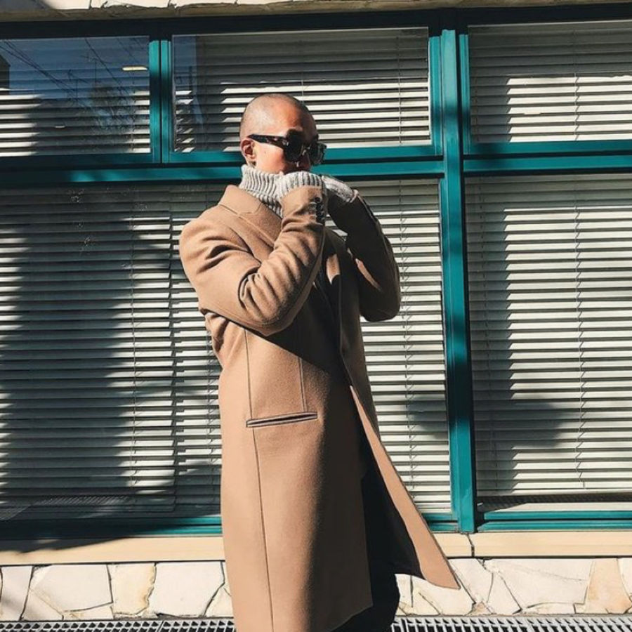 User Generated picture of a man wearing a long camel coat over a grey rolled neck sweater.
