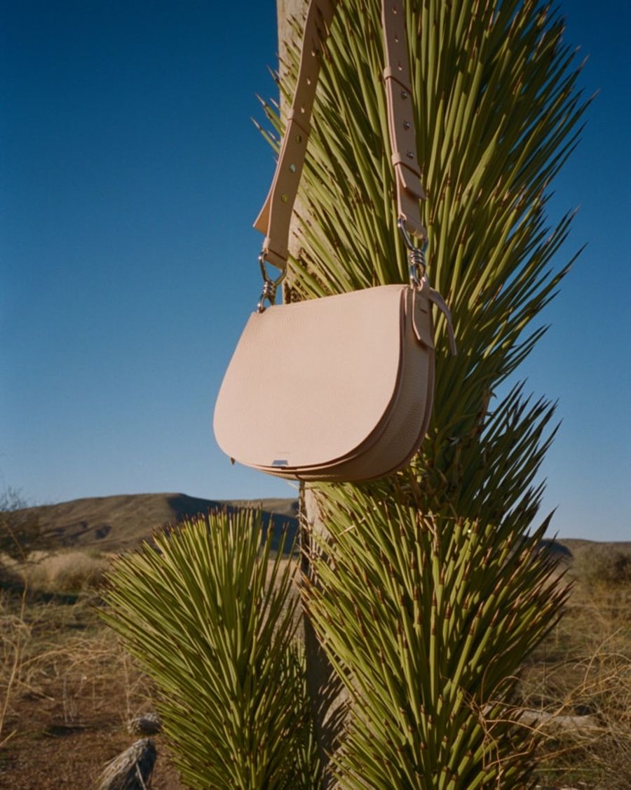 Close up of the Captain Lea Round Crossbody Bag with a desert background.